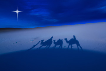 Camels and riders in the desert at night. Digitally added "Star of Bethlehem".