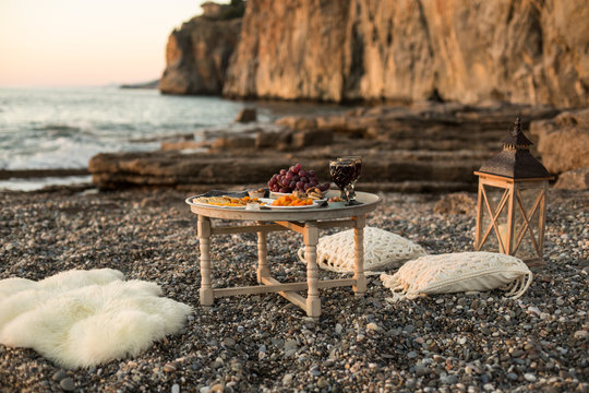 Romantic Dinner With Wine And Grapes By Seaside