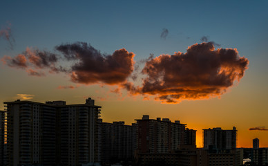 Fototapeta na wymiar Sunset cloud above the residential buildings