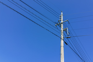 Electric powerline with pole and wire with clear blue sky background