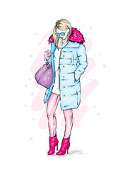 Stylish girl in a trendy winter coat, boots and with a bag. Vector illustration. Fashion skatech. Clothes and accessories.