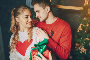 loving couple decorating Christmas tree