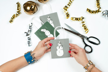 Woman wearing bracelet, Christmas gift on a wooden table background