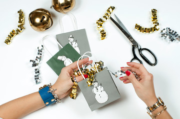 Woman wearing bracelet, Christmas gift on a wooden table background