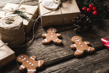 Christmas background with gingerbread, xmas tree and decoration on dark wooden board.