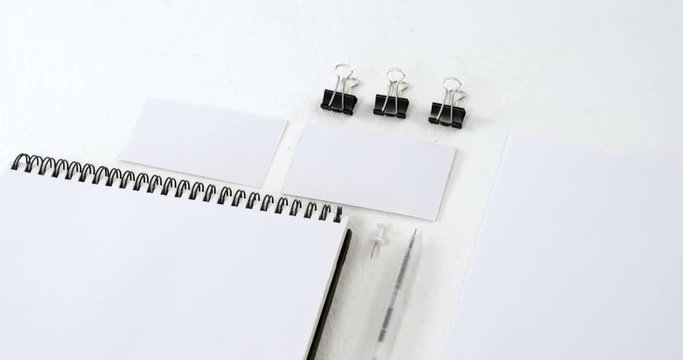 Paper clip, visiting card, organizer and pen on white background 