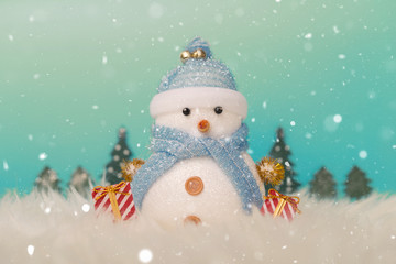 Happy snowman standing in gold winter christmas snow background. Merry christmas and happy new year greeting card with copy space. Christmas celebration holiday background.