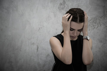 Portrait of stressed young caucasian woman with grey background
