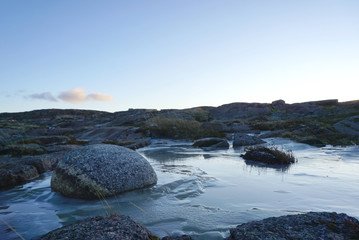 The landscape of round shape rock with iced pond in Terriberka