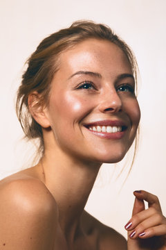 a girl smiling with nude make up