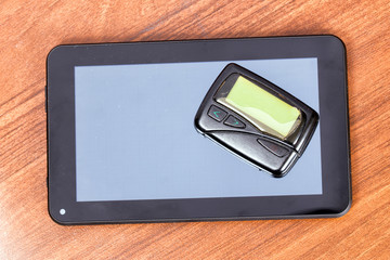 The old pager lies on a modern tablet