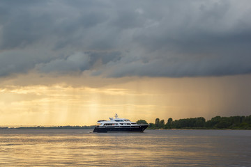 Yacht against the background of a sunset on the river