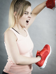 Angry woman holding shoe