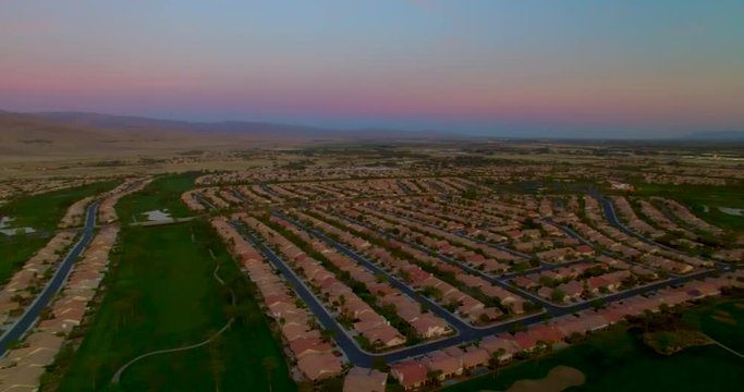 Panning aerial shot over Palm Desert in Palm Springs towards the sunset