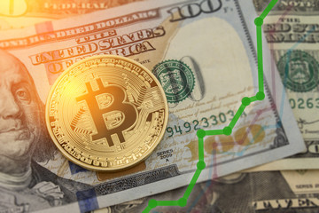 Bitcoin and dollar.  BTC market symbol cryptocurrency rising above the united states dollar.  Bitcoin on top of paper currency.  Copy space for text and wording.