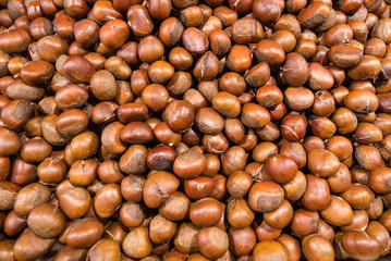 Organic chestnuts top view, seamless natural background.