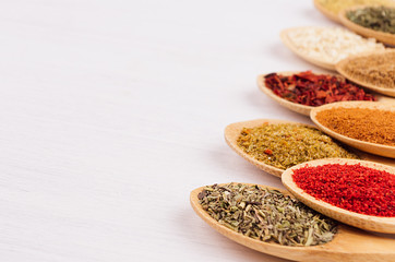 Spices collection on white soft wood board with copy space, closeup, blur.