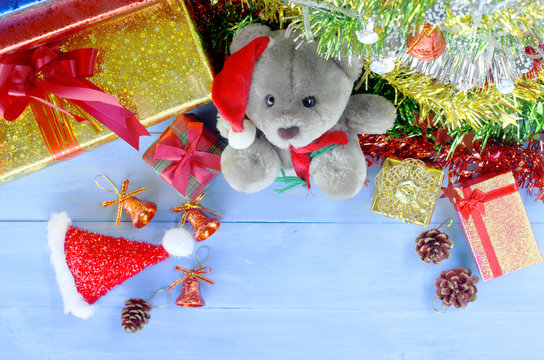 Christmas decorations with teedy doll and santa hat and gift box backgrounds above