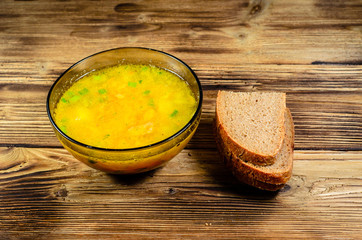 Vegetable soup in a glass bowl on wooden table