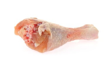 Raw chicken leg on a white background