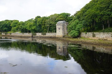 Ancient stone tower reflected in the lake