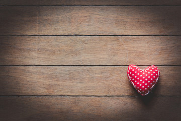 Heart shape toy on wooden background