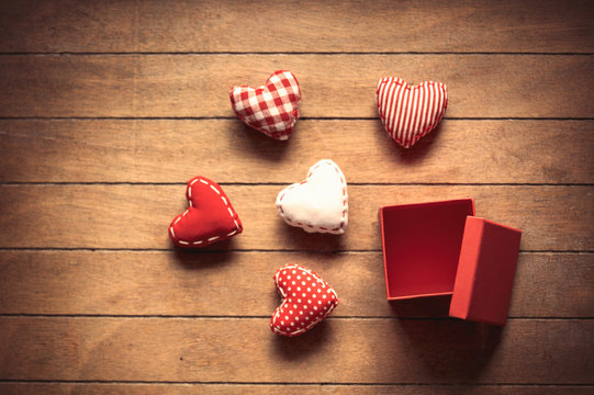 Heart shape toys and gift box on wooden background