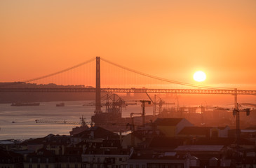Amazing sunset on Ponte 25 de Abril Bridge, (25th of April Bridge) at Lisbon. Portugal