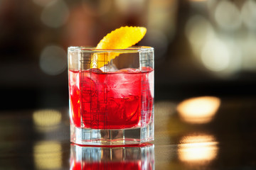 Closeup glass of red cherry juice at bar counter background.