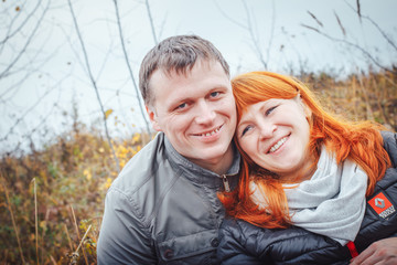 Fototapeta premium Couple man in white hat and woman with red hair outdoors