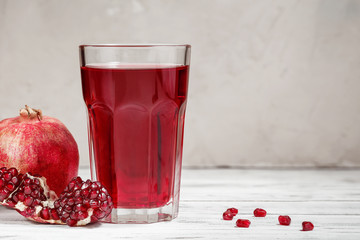 Glass of pomegranate juice with fresh pomegranate fruit