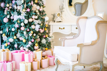 Christmas living room with a sofa, Christmas tree and gifts. Beautiful New Year decorated classic home interior. Winter background