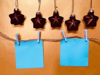 Blue blank memo papers on a golden background with Christmas decoration