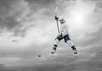 Fototapeta premium Ice hockey player on the ice, outdoors