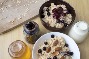 Delicious oatmeal porridge with berry and almonds for breakfast.
