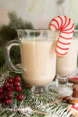 Eggnog, winter Christmas traditional hot drink with milk, eggs, rum. Christmass New Year decoration with gingerbread cookies.