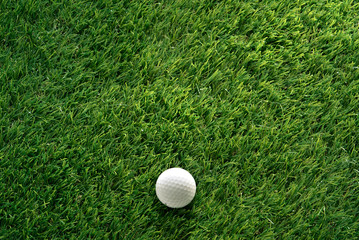 Golf ball on green grass in golf course