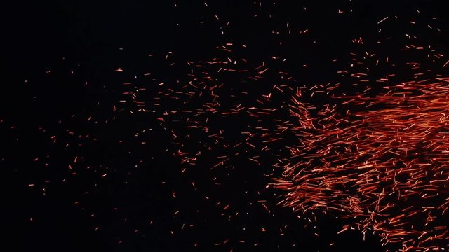 Whole swarm of sparks from nightly fire
