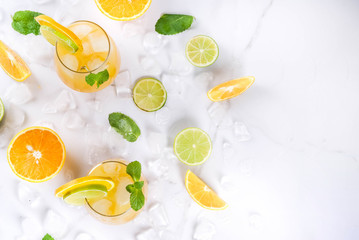 Vitamin summer refreshing drinks. Citrus punch with oranges and lime, with mint sprigs, chilled...