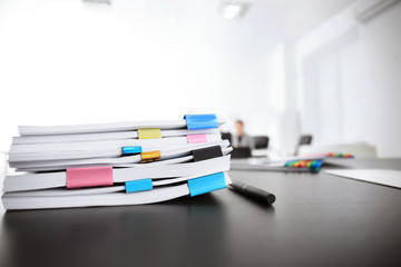 Stack of documents on table in office