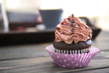 Tasty chocolate cupcake for Valentine's Day on wooden table