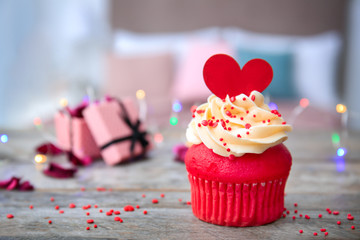 Tasty cupcake for Valentine's Day on wooden table
