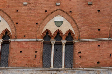 Fototapeta na wymiar Architectural detail of the Palazzo Pubblico at the Piazza del Campo in Siena, Italy, Europe