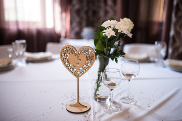 Wedding wooden table numbers in a shape of a heart.