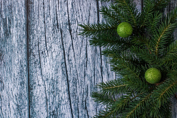 Branches of spruce with Christmas decorations on a background of old wooden panels, Christmas and New year background