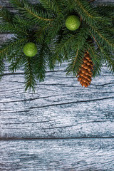 Branches of spruce with Christmas decorations on a background of old wooden panels, Christmas and New year background