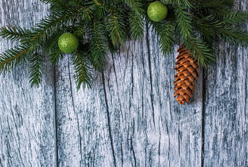 Branches of spruce with Christmas decorations on a background of old wooden panels, Christmas and New year background