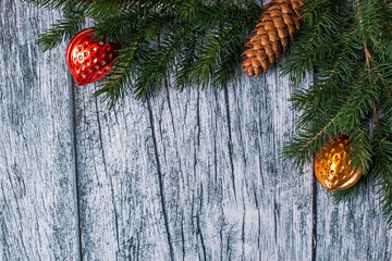 Branches of spruce with Christmas decorations on a background of old wooden panels, Christmas and New year background