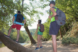 Hiker trekking on the trail in a forest. group tourists exploring nature walking through the woods