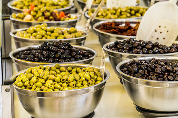 Different cured table olives in the bowls.